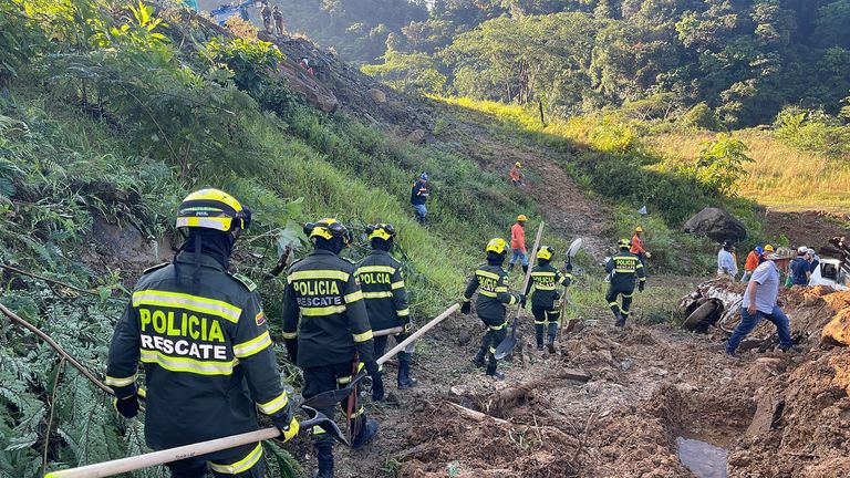 Rescuers search for survivors of a landslide caused by heavy rains in Choco