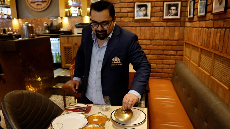 Amit Bagga, CEO of Daryaganj with a butter chicken and the lentil dish Dal Makhani 
Pic; Reuters