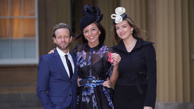 Davina McCall  with her partner Michael Douglas and her daughter Holly Robertson after being made a Member of the Order of the British Empire
Pic: PA