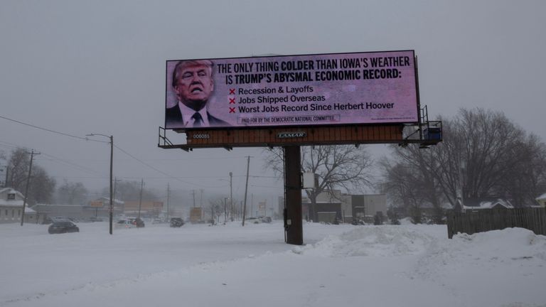 A billboard by the Democratic National Committee criticises Trump&#39;s record ahead of the Iowa vote