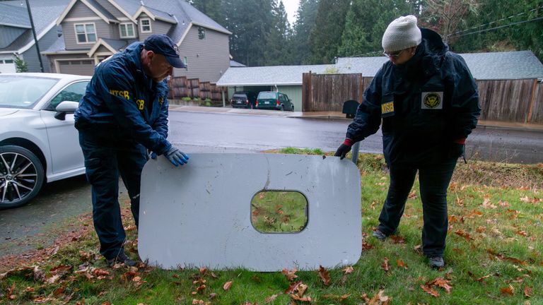 National Transportation Safety Board (NTSB) investigators examine the fuselage plug area of Alaska Airlines Flight 1282 Boeing 737-9 MAX, which was jettisoned and forced the aircraft to make an emergency landing, at a property where it was recovered in Portland, Oregon, U.S. January 8, 2024. NTSB/Handout via REUTERS. THIS IMAGE HAS BEEN SUPPLIED BY A THIRD PARTY