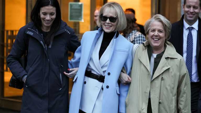 E. Jean Carroll, centre, smiles outside Manhattan Federal Court after the verdicts