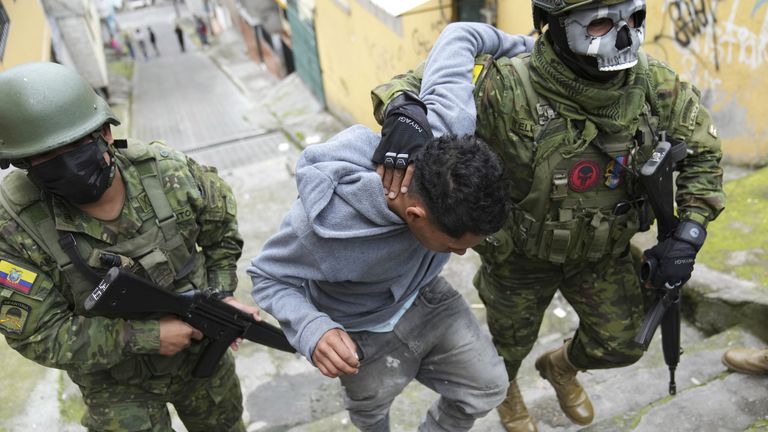 Soldiers briefly detain a youth to walk him to an area to check if he has gang-related tattoos as they patrol the south side of Quito, Ecuador, Friday, Jan. 12, 2024, in the wake of the apparent escape of a powerful gang leader from prison. President Daniel Noboa decreed Monday a national state of emergency, a measure that lets authorities suspend people’s rights and mobilize the military. (AP Photo/Dolores Ochoa)