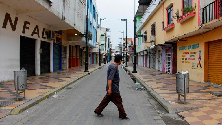 A man walks past closed stores in a normally busy commercial area near the border with Peru after a wave of violence in the country, prompting Peru's government to declare an emergency along its border with Ecuador, in Huaquillas, Ecuador January 10, 2024. REUTERS/Ralph Zapata NO RESALES. NO ARCHIVES
