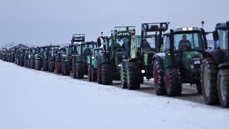 Tractors queue, as German farmers take part in a protest against the cut of vehicle tax subsidies, in Taufkirchen near Munich, Germany, January 8, 2024. REUTERS/Leo Simon
