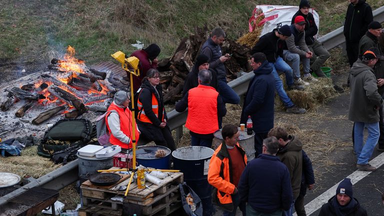 People gather during a blockade by farmers on the A4 in Jossigny.
Pic: Reuters