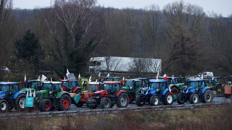 French farmers block a highway with their tractors during a protest in Longvilliers.
Pic: Reuters
