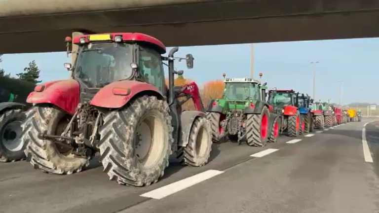 Tractors are used to enforce a blockade near Calais amid protests by French farmers.