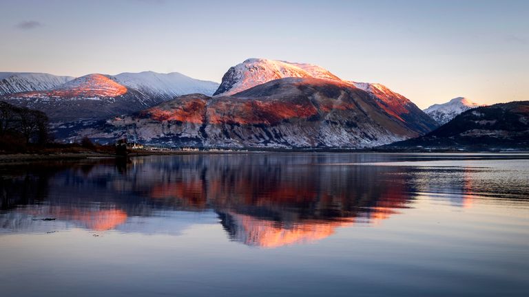 Ben Nevis looms over the wreck of the Golden Harvest fishing boat on the banks of Loch Linnhe near Fort William in the western Scottish Highlands. Picture date: Thursday January 11, 2024. PA Photo. See PA story WEATHER Cold. Photo credit should read: Jane Barlow/PA Wire