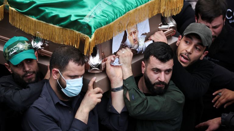 Arouri's coffin is carried at his funeral