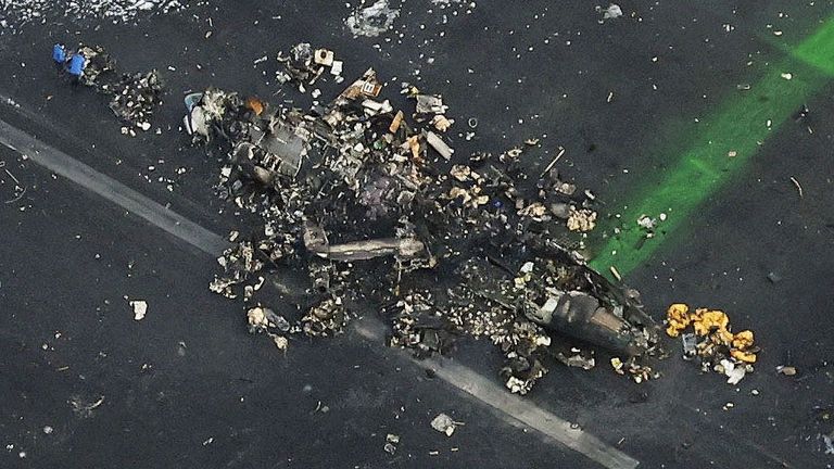 An aerial view shows burnt Japan Coast Guard aircraft after a collision with Japan Airlines&#39; (JAL) Airbus A350 plane at Haneda International Airport in Tokyo, Japan January 3, 2024, in this photo taken by Kyodo.