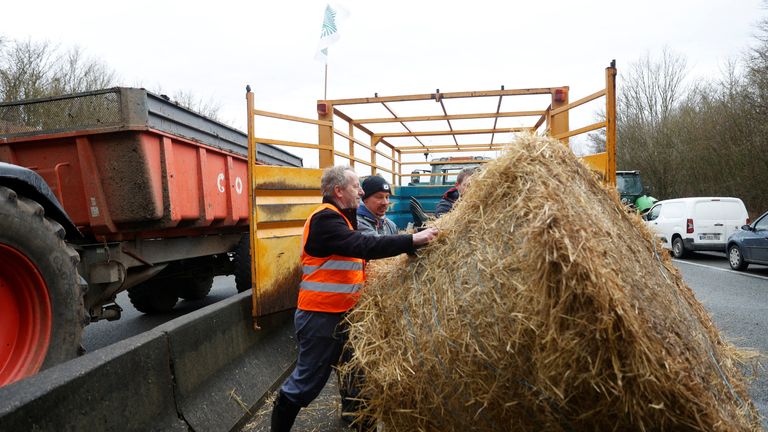 French farmers block the A16 highway with their tractors and hay bales  near Beauvais, France