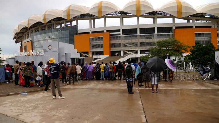 People wait at the Heroes National Stadium to find out news of their loved ones