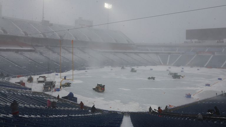 Workers remove snow from Highmark Stadium, where the NFL match had been due to kick off. Pic: AP