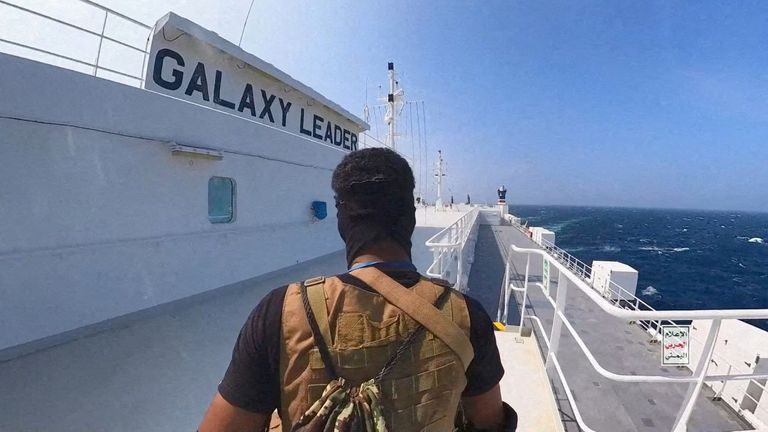     A Houthi fighter stands on the cargo ship Galaxy Leader in the Red Sea in this photo released on November 20, 2023. Houthi military media handout/release via Reuters This image was provided by a third party/report file photo, preview content, Free download : HOUTHI MILITARY MEDIA City: RED SEA Cou