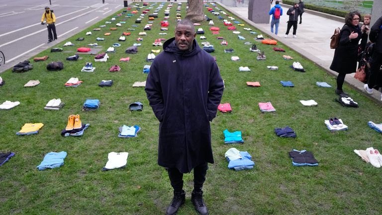 Idris Elba stands in Parliament Square with clothing representing the human cost of UK Knife Crime 
Pic:AP