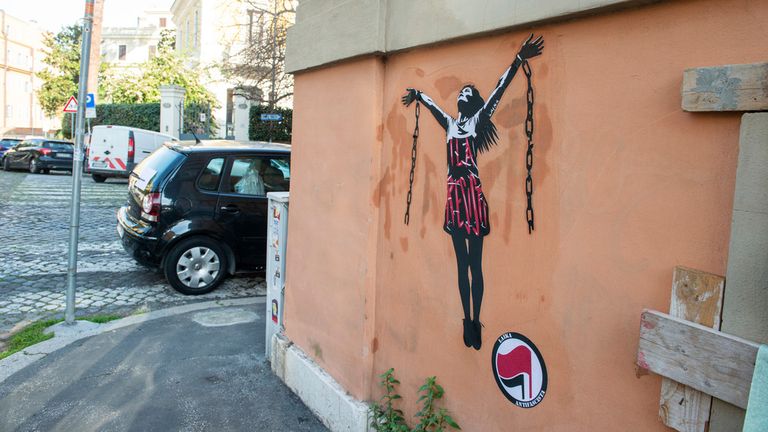 A mural painting depicting Italian antifascist activist Ilaria Salis in the act of breaking her chains near the Hungarian Embassy in Rome, Wednesday, Jan. 31, 2024. Italy has ramped up its protests over the treatment of Salis being held in a Hungarian jail after images of her appearing chained and shackled at a Budapest court hearing this week sparked outrage here. (Valentina Stefanelli/LaPresse via AP)
