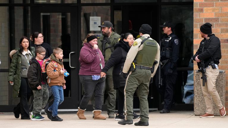 Families are reunited at a community building following the shooting at Perry High School, Thursday, Jan. 4, 2024, in Perry, Iowa. (AP Photo/Charlie Neibergall)