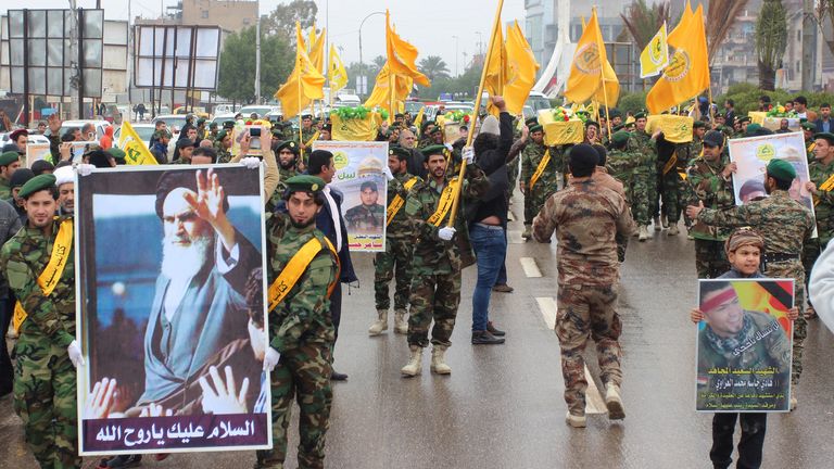 Members of the Shiite group Liwa Sayyid al-Shuhada, part of the Islamic Resistance in Iraq that supports Syrian President Bashar al-Assad, carry the coffins of their group's fighters during a funeral in Basra, 420 kilometers (261 miles) away.  Southeast Baghdad, January 6, 2014. Hundreds of mourners gathered in southern Iraq's Basra province on Monday to attend the funeral of six Shiite militants killed in fighting in Syria while defending the famous shrine of Sayyida Zeinab in Damascus.  re