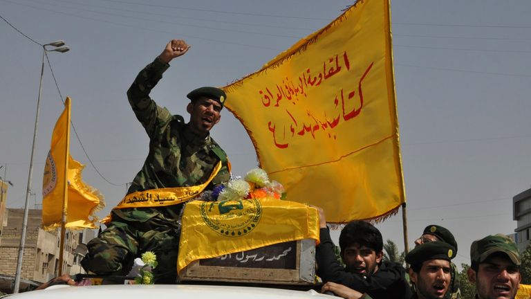 Mourners carry the coffin of a Shiite fighter from the pro-Assad Sayyid al-Shuhada Brigades during a funeral in Basra, 420 kilometers (261 miles) southeast of Baghdad, August 27, 2013. Four Shiite fighters from the Sayyid al-Shuhada Brigades and members of the Sayyid al-Shuhada Brigades were killed during clashes with the Free Syrian Army. On the outskirts of Damascus, according to their relatives.  The text on the flag reads, "The Islamic Resistance in Iraq, Sayyid al-Shuhada Brigades".  Reuters/Stringer (Iraq - Tags: conflict and civil unrest)