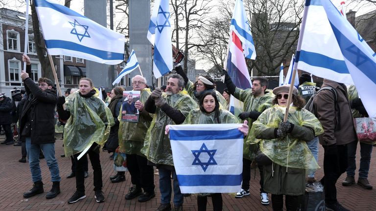 Protestors wave Israeli and Dutch flags, and hold photos of the hostages kidnapped during the Oct. 7 Hamas cross-border attack in Israel, during a demonstration outside the International Court of Justice in The Hague, Netherlands, Thursday, Jan. 11, 2024. The United Nations&#39; top court opens hearings Thursday into South Africa&#39;s allegation that Israel&#39;s war with Hamas amounts to genocide against Palestinians, a claim that Israel strongly denies. Pic: AP Photo/Patrick Post