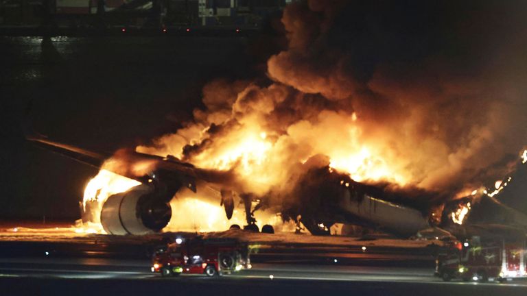 The plane on fire on the runway of Haneda airport. Pic: AP