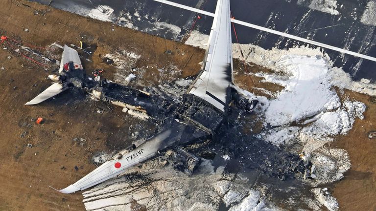 The burnt-out remains of the Japan Airlines plane at Haneda airport. Pic: AP