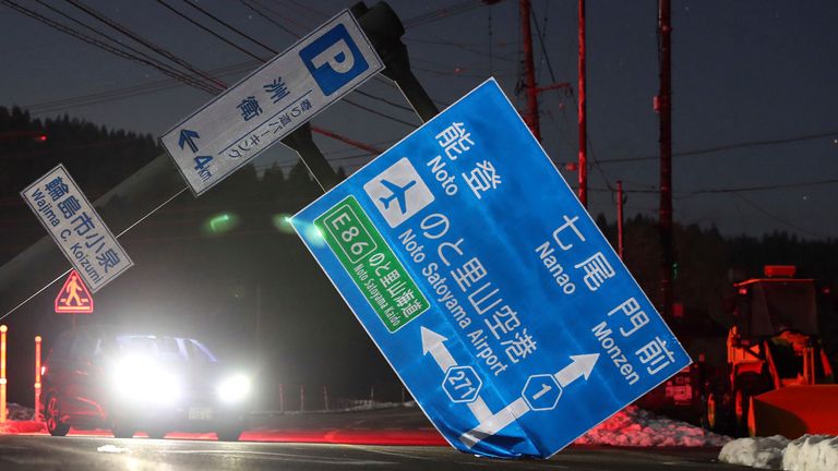 An information board of roads collapses due to a massive earthquake and blocks the road in Wajima City, Ishikawa Prefecture on January 2, 2024. A massive earthquake occurred near Ishikawa Prefecture of Noto Peninsula, and a major tsunami warning was issued for the Noto region. The Japan Meteorological Agency announced that the magnitude was 7.6.( The Yomiuri Shimbun via AP Images )