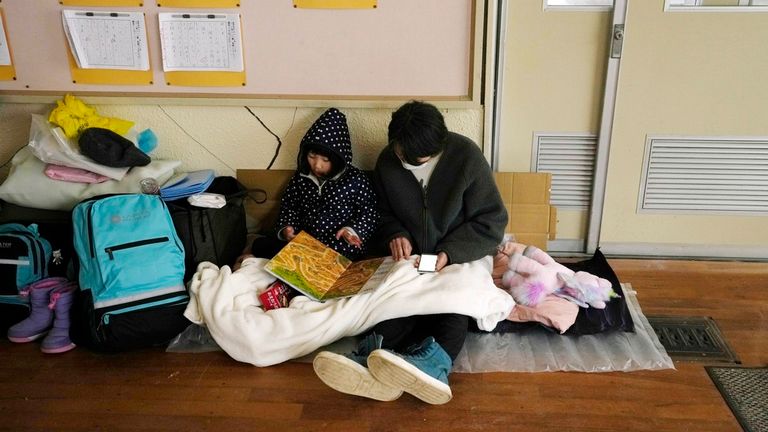 Evacuees rest at a temporary evacuation center in Suzu in the Noto peninsula facing the Sea of Japan, northwest of Tokyo, Wednesday, Jan. 3, 2024, following Monday's deadly earthquake. (AP Photo/Hiro Komae)