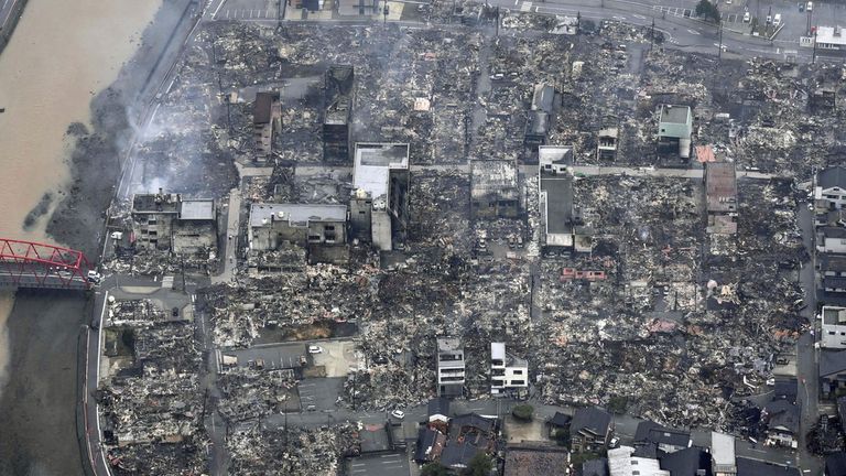 This aerial photo shows an area hit by a fire following earthquakes in Wajima, Ishikawa prefecture, Japan Wednesday, Jan. 3, 2024. A series of powerful earthquakes that hit western Japan left multiple people dead and damaged thousands of buildings, vehicles and boats. Officials warned Tuesday that more quakes could lie ahead.  (Kyodo News via AP)