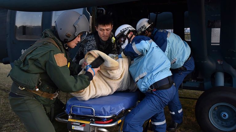 In this photo provided by Japanese Ministry of Defense, Japanese Self Defense Force members carry an injured person into a helicopter, following strong earthquakes in Suzu, Ishikawa prefecture, Japan, Jan. 2, 2024. (Japanese Ministry of Defense via AP)