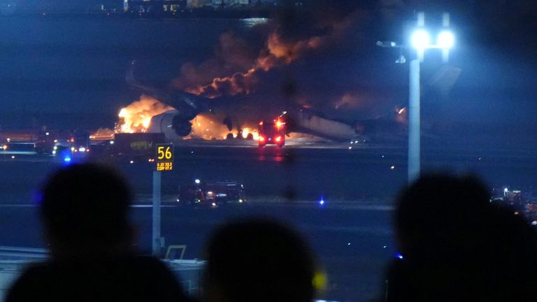 A Japan Airlines plane catches fire on the runway at Haneda Airport in Ota Ward, Tokyo on Jan.2nd, 2024, firefighting efforts are underway. The fire started on the aircraft just as it landed. Haneda Airport has blocked the runway. According to TV and other images, the plane caught fire from the rear of the fuselage almost as soon as it landed. It is possible that the plane collided with a Japanese Coast Guard aircraft.( The Yomiuri Shimbun via AP Images )
