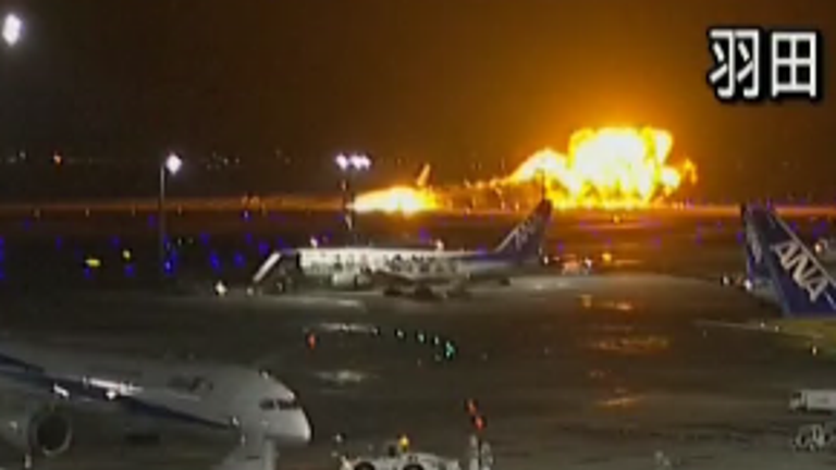 CCTV footage shows moment Japan Airlines plane burst into flames on runway