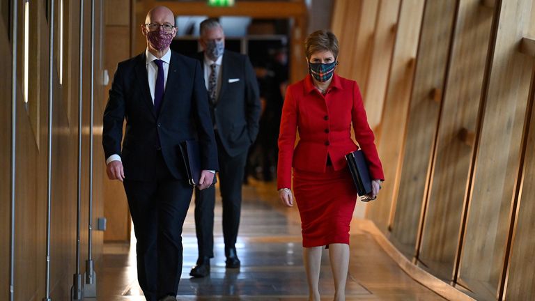 First Minister Nicola Sturgeon and Deputy First Minister John Swinney arrive before she delivered a Covid-19 update statement in the main chamber at the Scottish Parliament, Edinburgh. Picture date: Tuesday December 14, 2021.