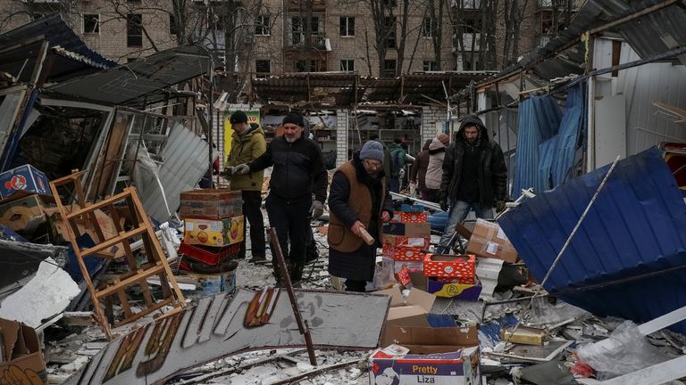 Local residents collect goods at a street market destroyed during a Russian missile attack, amid Russia&#39;s attack on Ukraine, Kharkiv, Ukraine January 23, 2024. REUTERS/Sofiia Gatilova