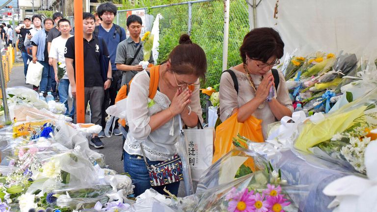 People visit the arson site of Kyoto Animation Co., Ltd. (so-called Kyoani) to offer a prayer for the victims in Kyoto on July 28, 2019, 10 days after the case. On the morning of 18th, a fire occurred with an explosion sound at a studio of an animation production company "Kyoto Animation" in Fushimi Ward, Kyoto City and 35 staffs died....41-year-old man Shinji Aoba allegedly splashed gasoline in the building while screaming "Die!" reportedly said, "They stole my idea" when Aoba was taken by police. Kyoto Animation produced poplar animations such as "K-On!", "The Melancholy of Haruhi Suzumiya" and" Sound! Euphonium".     ( The Yomiuri Shimbun via AP Images )