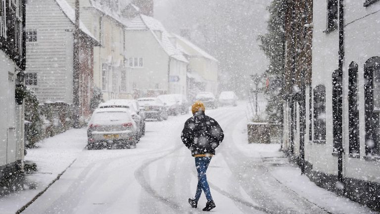 A person walks through snow in Lenham, Kent, on Monday