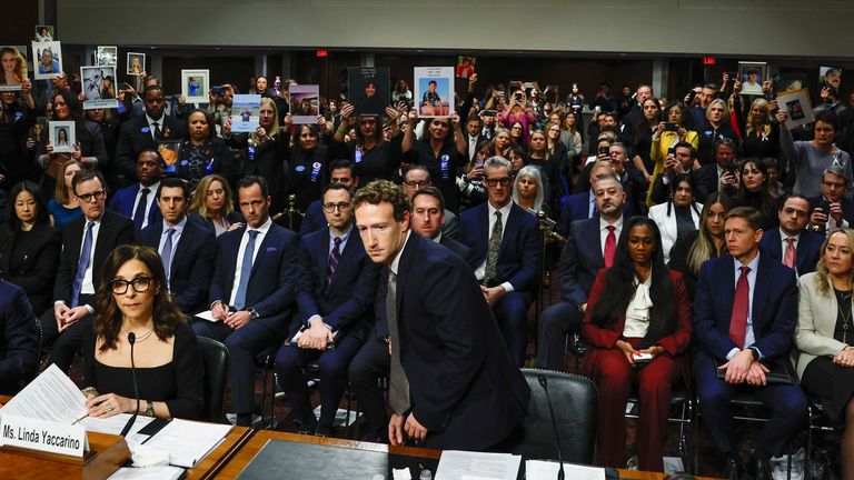 Mark Zuckerberg returns to his seat after standing and facing the public.
Pic: Reuters