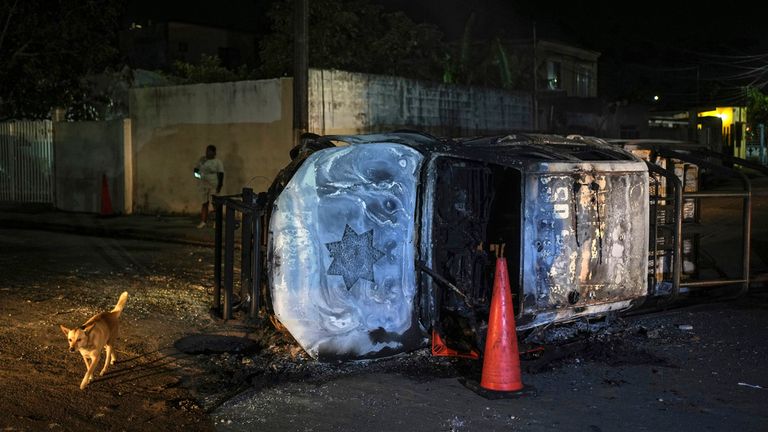 A damaged Veracruz state police patrol car lays on its side, burned by residents protesting the death of Brando Arellano Cruz, fatally shot by police after he failed to pull over, in Lerdo de Tejada near Veracruz, M..xico, Saturday, Jan. 19, 2024. Four municipal police officers are under investigation in relation to the death of the young man, after the victim&#39;s neighbors staged violent protests and attempted to lynch the officers. (AP Photo/Felix Marquez)