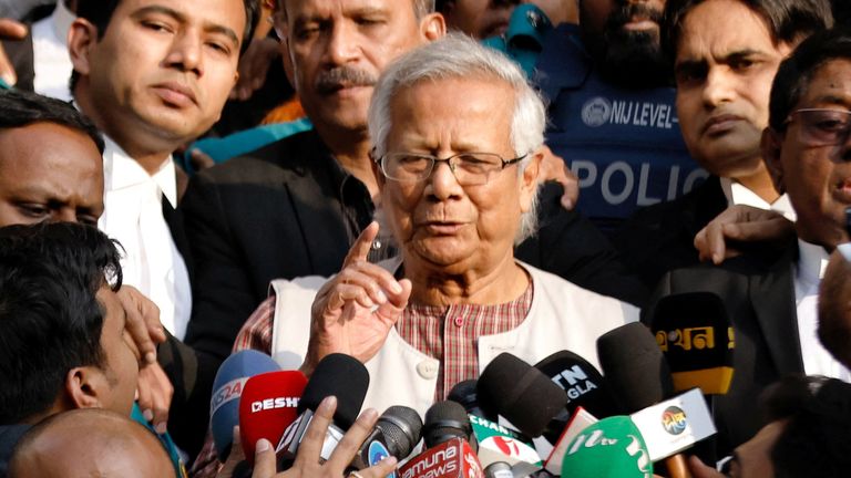 Professor Muhammad Yunus gestures outside court in Dhaka after being sentenced to six months in prison
