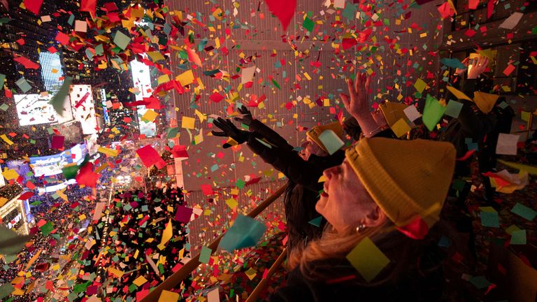 Volunteers throw confetti as the clock strikes midnight. Pic: AP