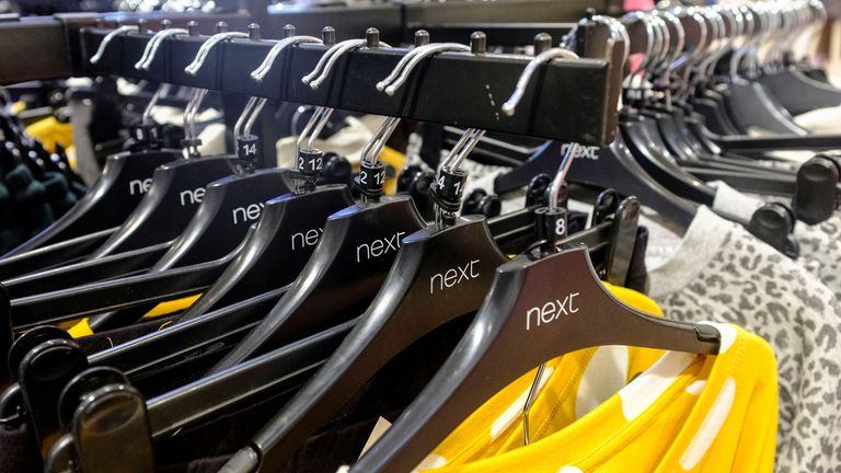 Garments on coat hangers are pictured at a store of clothing retailer Next, in London, Britain, November 17, 2021. Picture taken November 17, 2021. REUTERS/May James