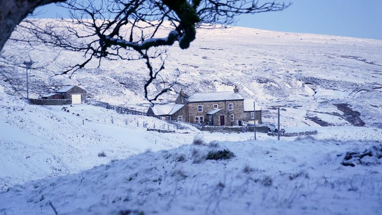 A snow covered cottage surrounded by fields near Carrshields in Northumberland