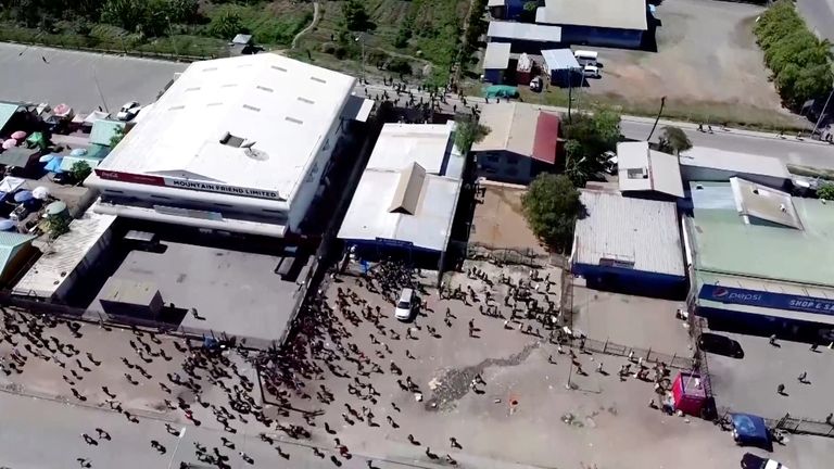 People gather near a building, amid reports of widespread looting and arson as police and the public sector protest over a pay cut that officials blamed on an administrative glitch, in Port Moresby, Papua New Guinea
Pic:Mackenzie Waide/Reuters