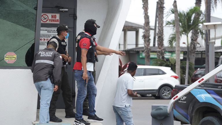 Police respond to an attack at the TC Television network, a public television channel in Guayaquil, Ecuador, Tuesday, Jan. 9, 2024. Masked men broke onto the set waving guns and explosives during a live broadcast Tuesday. (AP Photo/Cesar Munoz)