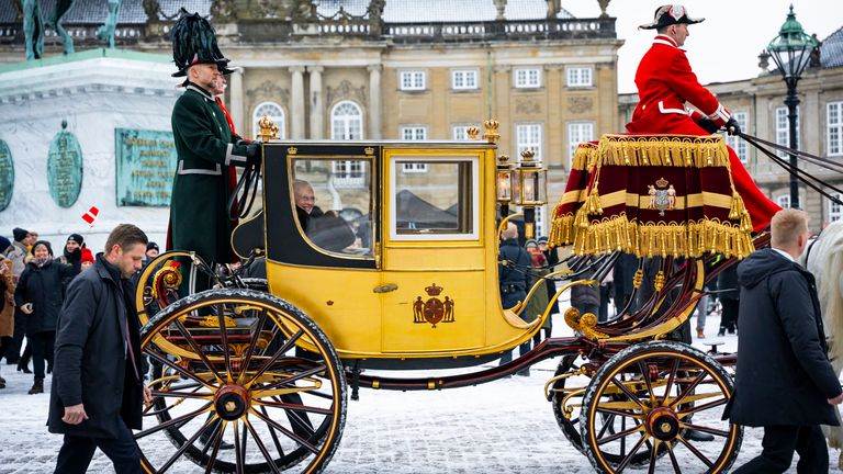 Queen Margaret of Denmark waves as she is escorted by a hussar regiment, as she rides a horse-drawn coach from Christian IX's Palace, Amalienborg to Christiansborg Palace in Copenhagen, Denmark, Thursday, January 4, 2024. Europe& Queen Margaret, Britain's longest-reigning monarch, traveled through the Danish capital Thursday in a gilded carriage. Drawn by horses, she concluded her final New Year celebrations before her abdication later this month.  (Emil Nicolai Helms/Ritzau Scanpix via AP)