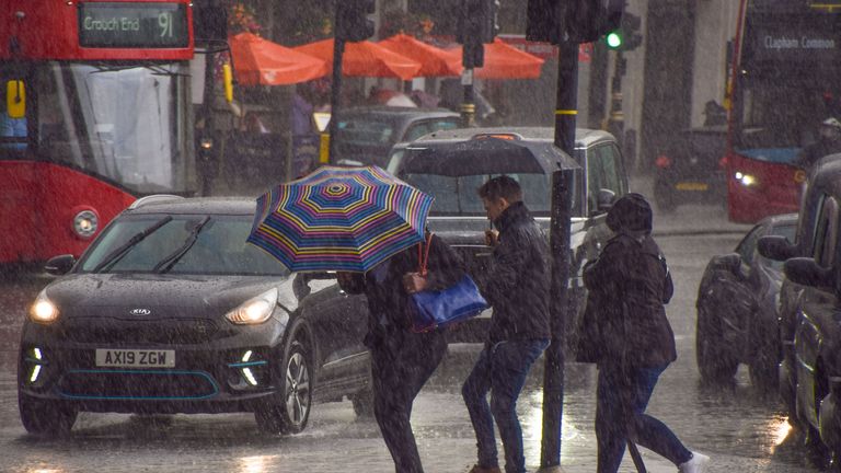 People run for cover in Trafalgar Square as torrential rain falls. Pic: iStock