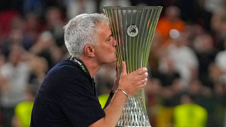 Roma&#39;s head coach Jose Mourinho, right, kisses the trophy at the end of the Europa Conference League final soccer match between AS Roma and Feyenoord at National Arena in Tirana, Albania, Wednesday, May 25, 2022. AS Roma won 1-0. (AP Photo/Thanassis Stavrakis)