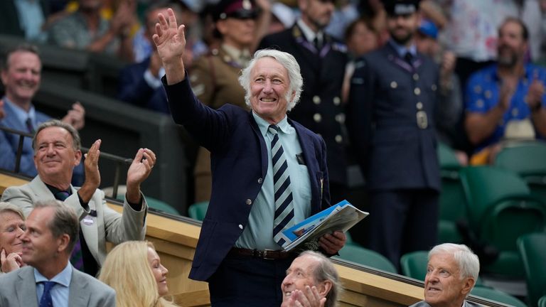 Rugby legend JPR Williams waves as he stands in the Royal Box after being introduced on Centre Court on day six of the Wimbledon tennis championships in London, Saturday, July 8, 2023. (AP Photo/Alastair Grant)