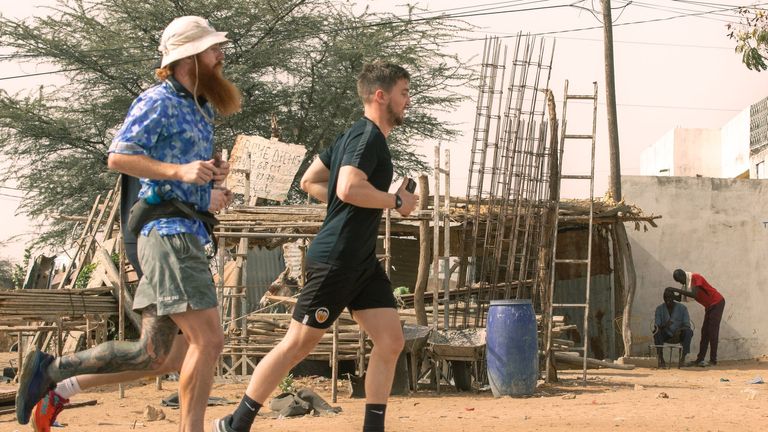 Russ Cook (left) is pictured running through Senegal as he aims to run across Africa. Image: X/@thehardestgeezer